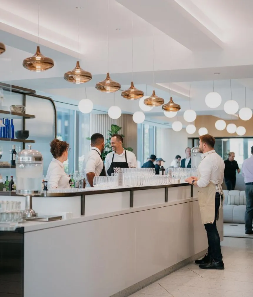 Modern Café & Cocktail Bar featuring a lengthy counter and the Well& by Durst logo on the wall during a corporate event