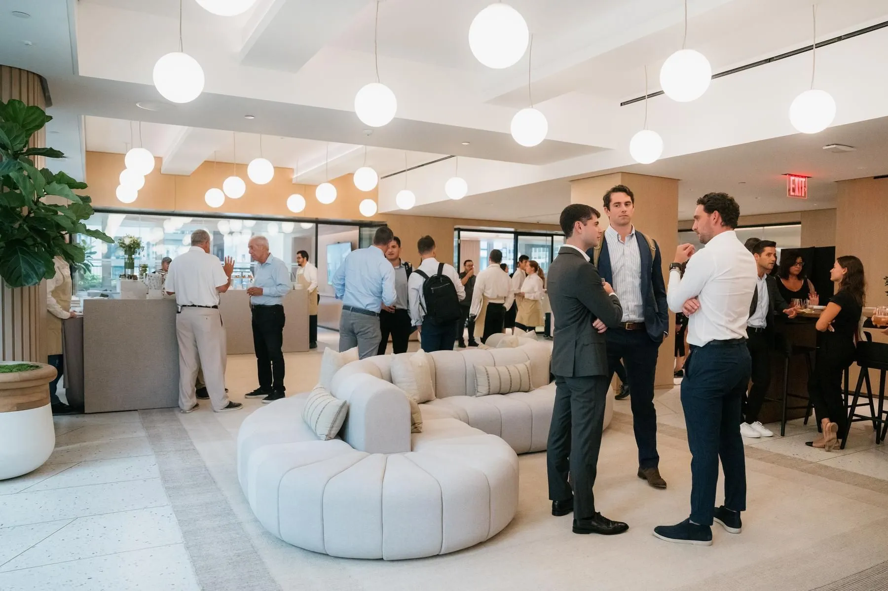 Individuals interacting and networking  during a corporate event at 825 Third Avenue, fostering connections and exchanging ideas