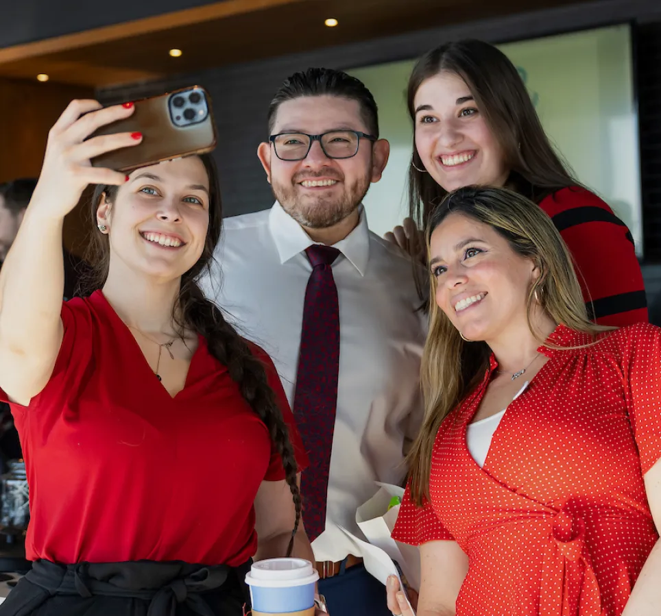 A diverse group of individuals smiling and posing for a photo together.