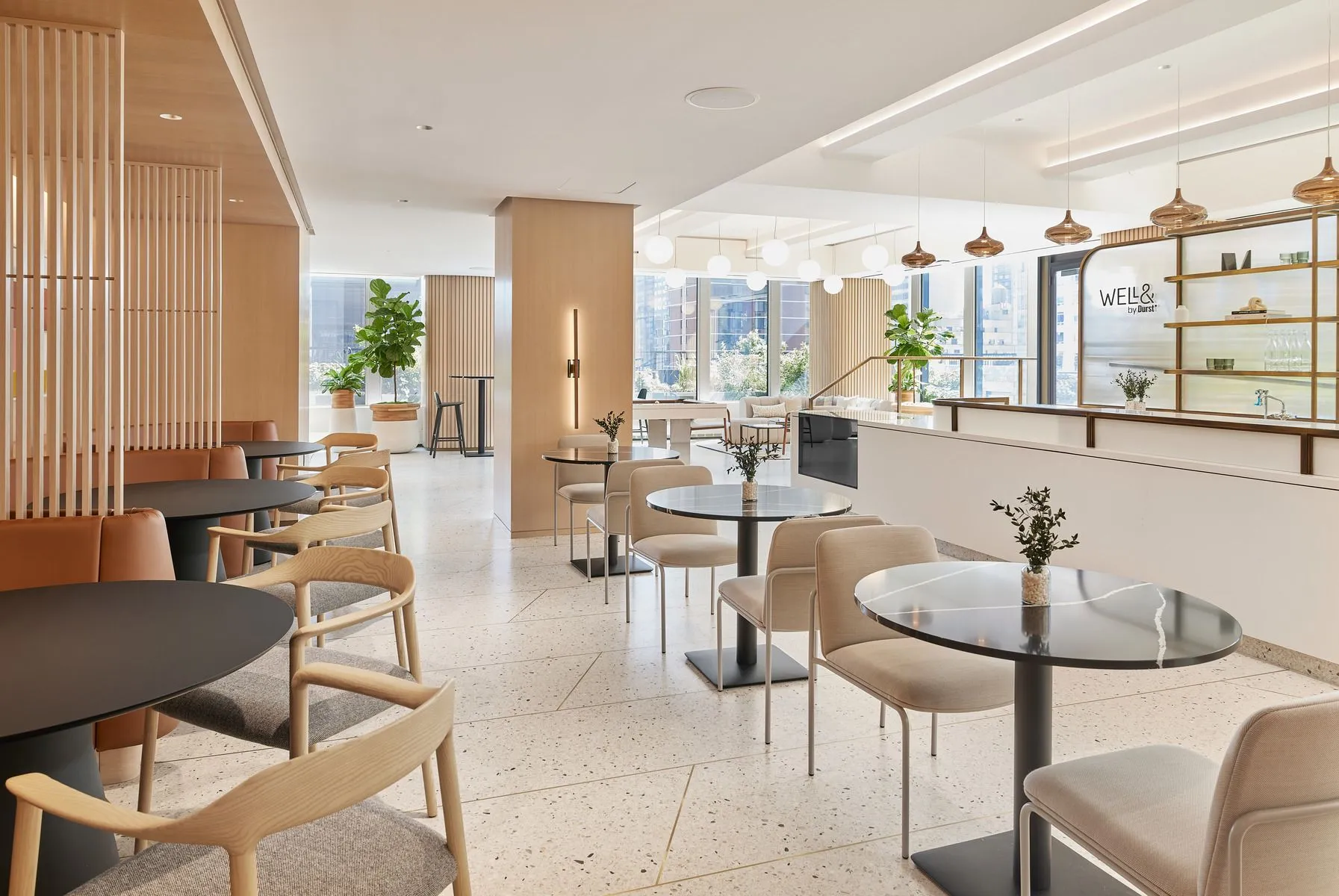 A contemporary 825 Third Avenue's Café & Cocktail Bar featuring a stylish bar area and comfortable chairs for relaxation and collaboration.